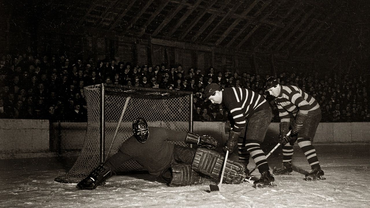 Vintage flash photograph of a goalie sprawled in the crease